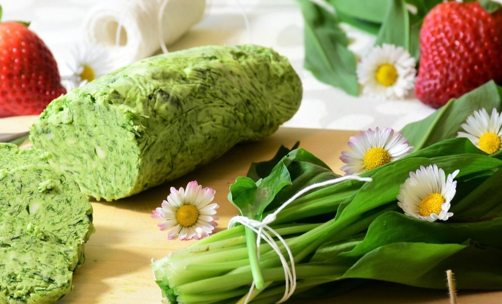 Picture of different herbs and flowers on a plate.